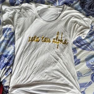 White Zeta Tau Alpha Shirt With Gold Lettering
